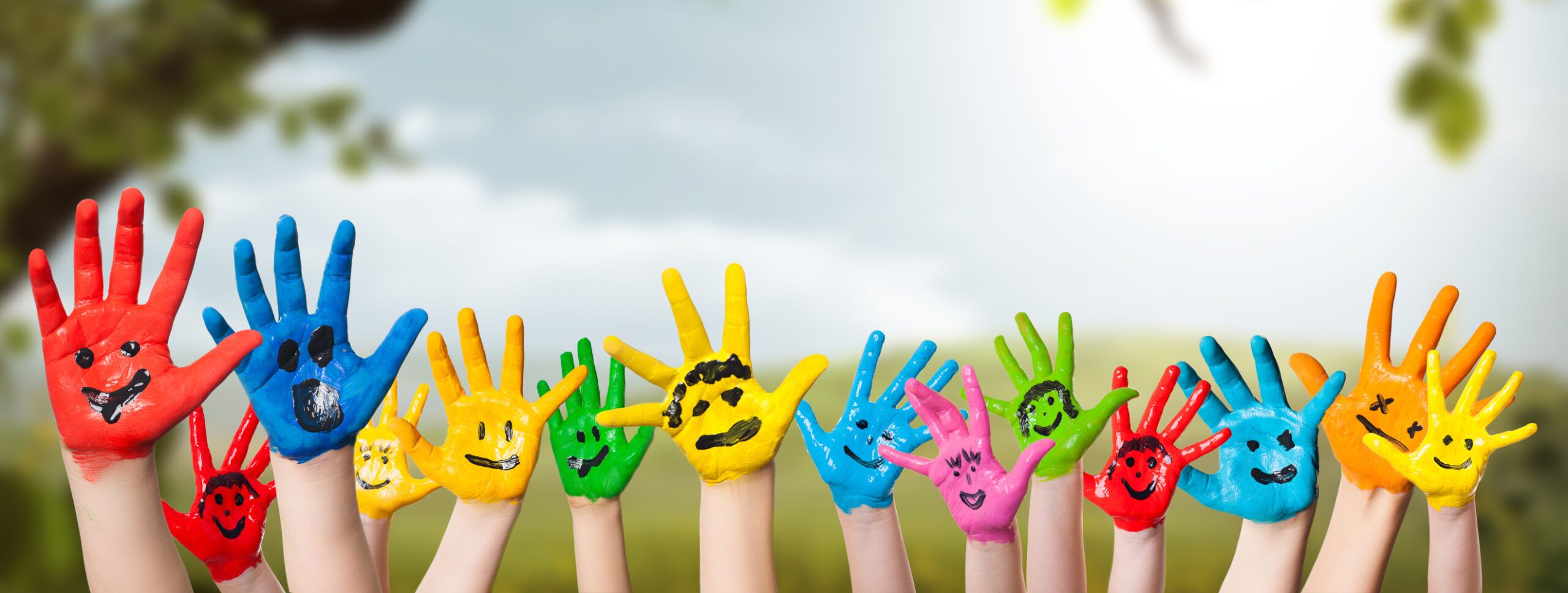 colorful,painted,hands,in,front,of,a,spring,scene